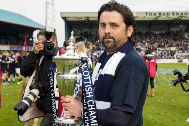 Dundee manager Paul Hartley celebrates with the trophy Picture: SNS