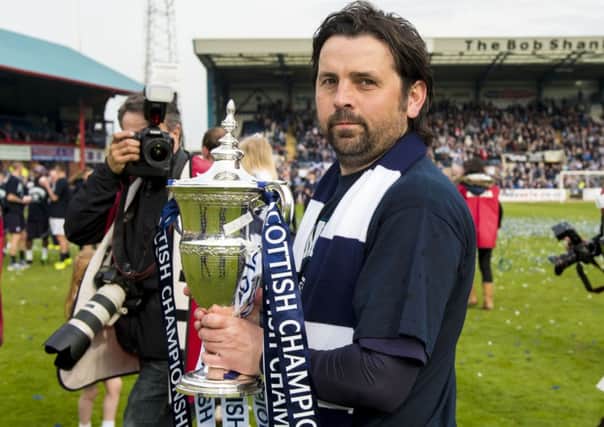 Dundee manager Paul Hartley celebrates with the trophy Picture: SNS