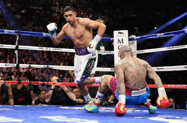 Amir Khan heads towards a neutral corner after knocking down Luis Collazo. Picture: Reuters