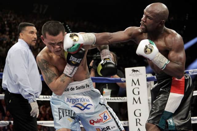 Floyd Mayweather Jr. slams a right to the face of Marcos Maidan. Mayweather dominated with a 12 round split decision over Maidana. Picture: Getty