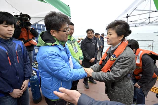 President Park Geun-hye, right, consoles a relative of a passenger on the Sewol. Picture: Yonhap/AP