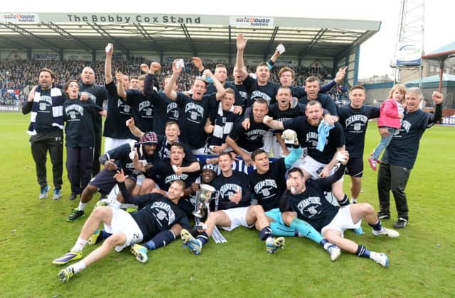 Dundee celebrate clinching the SPFL Championship title and promotion to the Premiership. Picture: SNS