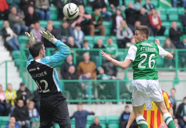 Sam Stanton rises to loop the ball over Partick goalkeeper Paul Gallacher for a late equaliser. Picture: Neil Hanna