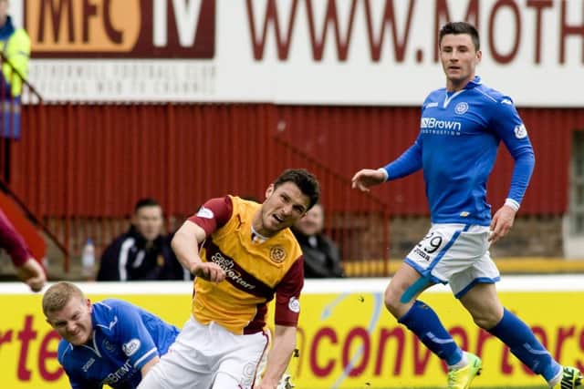 John Sutton is brought to ground by St Johnstones Brian Easton during a hard-fought clash. Picture: SNS