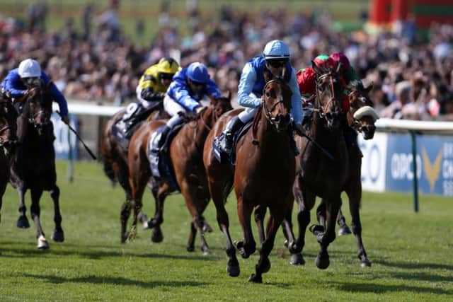 Miss France, ridden by Maxime Guyon in blue silks, pulls clear of the chasing pack at Newmarket. Picture: Steve Parsons/PA