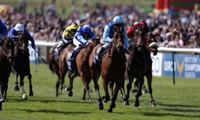 Miss France, ridden by Maxime Guyon in blue silks, pulls clear of the chasing pack at Newmarket. Picture: Steve Parsons/PA