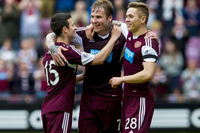 Ryan Stevenson (centre) celebrates his second with team-mates Sam Nicholson (right) and Jason Holt. Picture: SNS