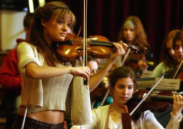 Nicola Benedetti  playing in 2005, right. The violinist took her first steps to stardom by winning the BBCs Young Musician of the Year title. Picture: David Moir