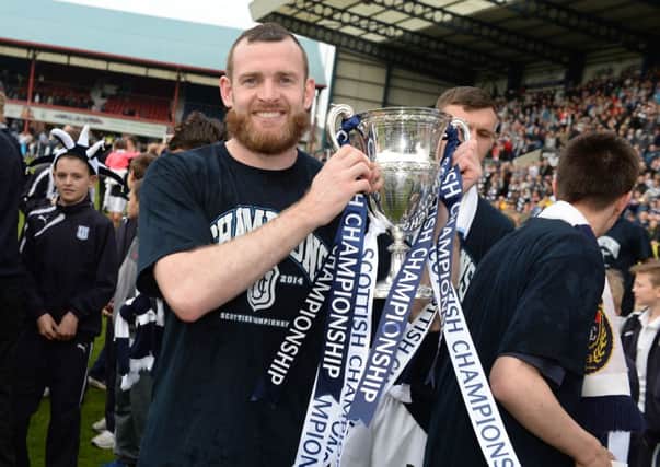 Craig Beattie of Dundee celebrates winning the title. Picture: SNS