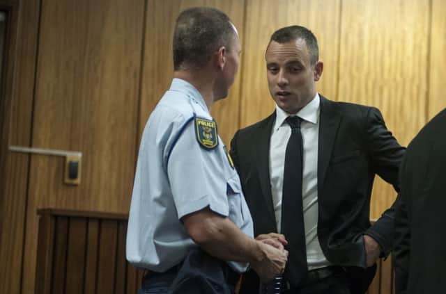 Oscar Pistorius speaks with a member of the courtroom staff during his ongoing murder trial, in Pretoria. Picture: Getty