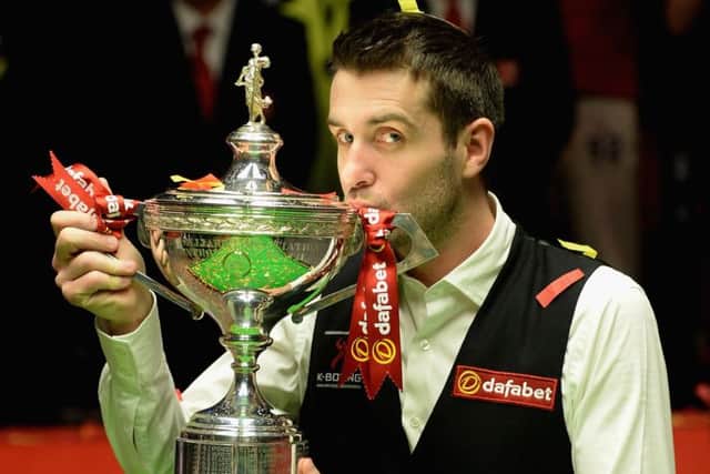 Mark Selby lifts the trophy after beating five-time champion Ronnie OSullivan to land the World Championship title. Picture: Getty