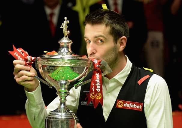 Mark Selby lifts the trophy after beating five-time champion Ronnie OSullivan to land the World Championship title. Picture: Getty