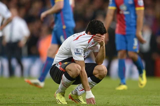 Liverpool's Luis Suarez is a picture of dejection at the final whistle. The Anfield side threw away a 3-0 lead. Picture: PA