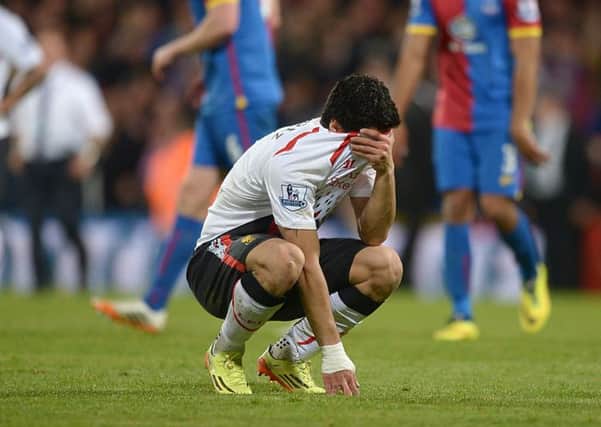 Liverpool's Luis Suarez is a picture of dejection at the final whistle. The Anfield side threw away a 3-0 lead. Picture: PA