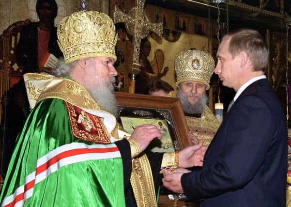 On this day in 2000, Patriarch Alexy II blessed Vladimir Putin on his inauguration as the new Russian president. Picture AFP