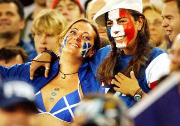 A Scotland supporter and French fan watch their teams at the 2003 Rugby World Cup. Picture: PA