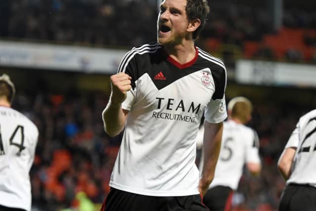 Hat-trick hero Scott Vernon celebrates after putting the game beyond Dundee United. Picture: SNS