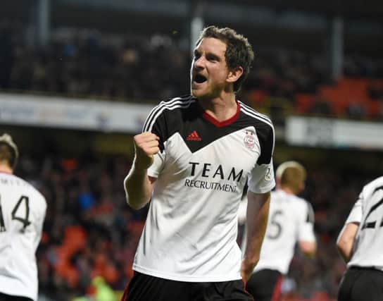 Hat-trick hero Scott Vernon celebrates after putting the game beyond Dundee United. Picture: SNS
