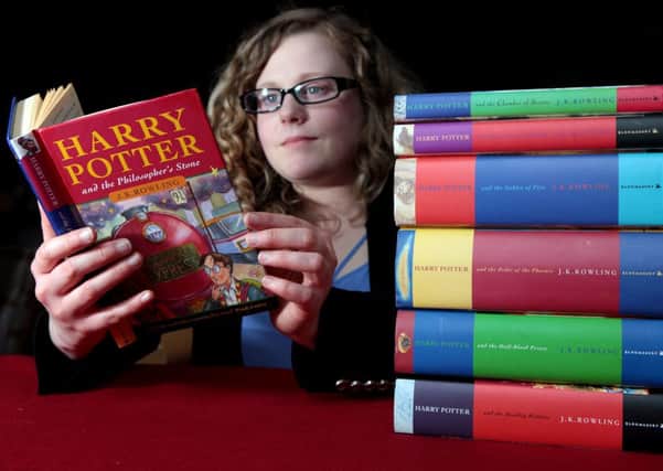 Book specialist Cathy Marsden looks over a complete set of first edition Harry Potter books. Picture: Hemedia