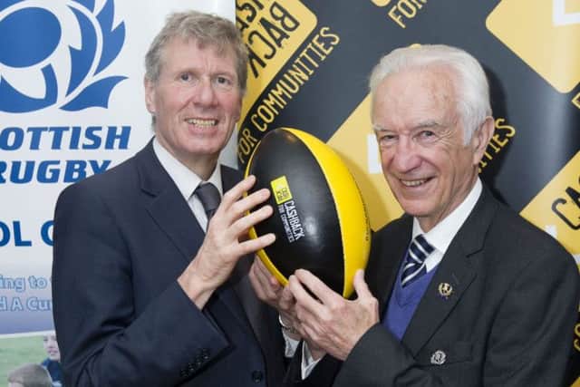 Justice Secretary Kenny MacAskill and SRU president Donald Macleod celebrate the handover. Picture: SNS/SRU