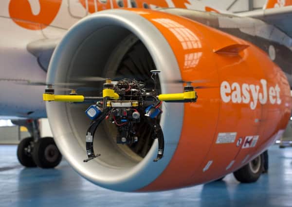 Flying drones inspect an EasyJet aircraft at Luton Airport. Picture: Tim Anderson