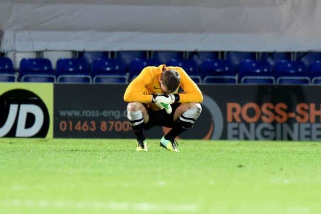 Hibs keeper Ben Williams cuts a dejected figure after defeat in Dingwall. Picture: SNS