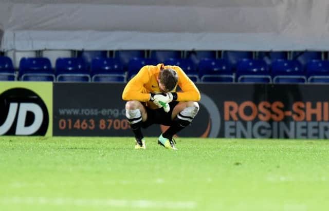 Hibs keeper Ben Williams cuts a dejected figure after defeat in Dingwall. Picture: SNS