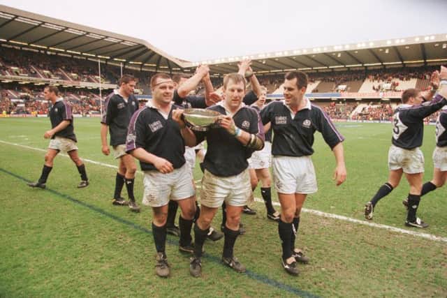 Gary Armstrong, centre, alongside Scotland team-mates as he carries the Centenary Quaich in 1999. Picture: TSPL