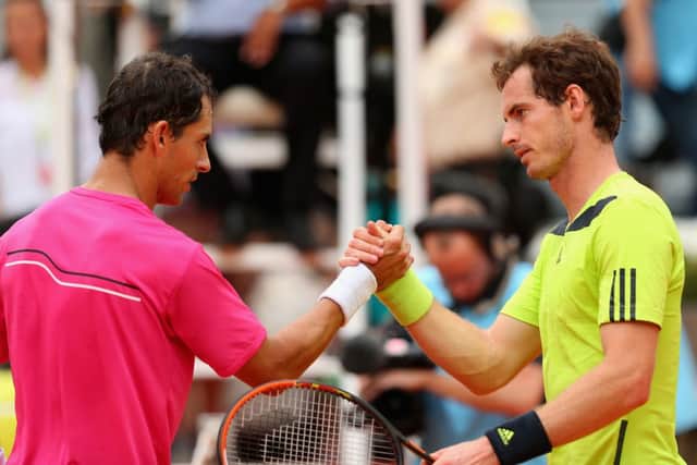 Andy Murray shakes hands at the net after his straight sets defeat by Colombian Santiago Giraldo. Picture: Getty