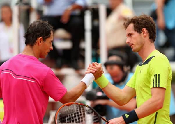 Andy Murray shakes hands at the net after his straight sets defeat by Colombian Santiago Giraldo. Picture: Getty
