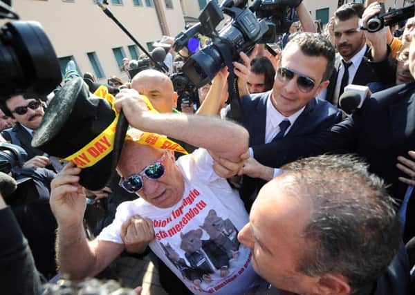 A protester demands Silvio Berlusconi serve jail time for taxation fraud. Picture: Getty