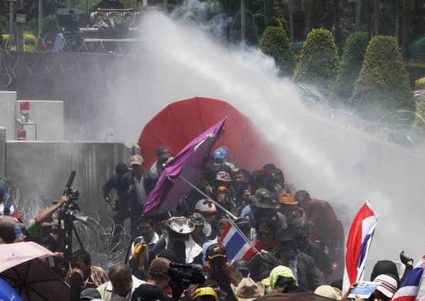 Police fire tear gas and a water cannon at antigovernment protesters. Picture: Reuters