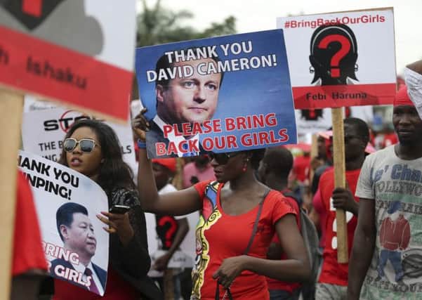 Potesters in Lagos carry signs appreciating international support.        Picture: Reuters