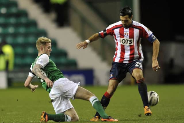 Danny Handling and Manuel Pascali vie for the ball during Hibernian's 3-0 win over Kilmarnock last year. Picture: Phil Wilkinson