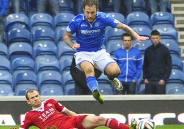 Mark Reynolds slides in to tackle St Johnstone's Stevie May. Picture: Robert Perry