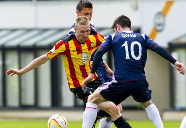 Partick Thistle's Chris Erskine (left) tries to skip past Rocco Quinn. Picture: SNS