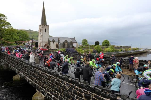 The peloton passes through Glenarm village during stage two of the Giro dItalia. Picture: PA