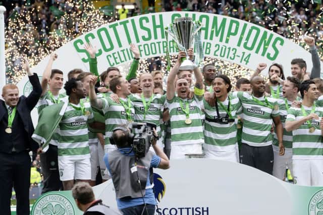 The Celtic players celebrate at full-time with the Scottish Premiership trophy Picture: SNS