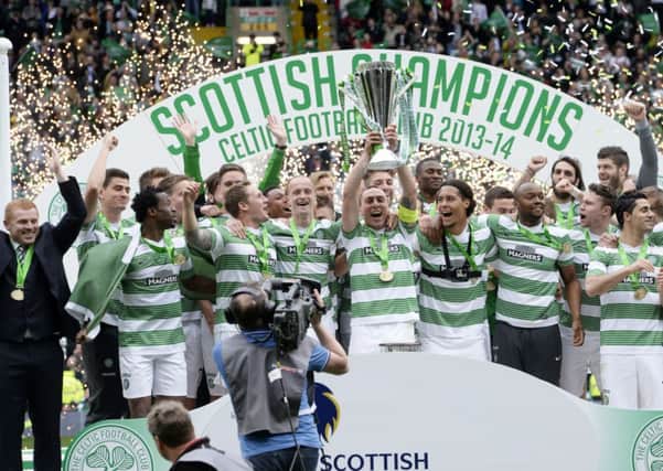 The Celtic players celebrate at full-time with the Scottish Premiership trophy Picture: SNS