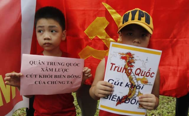 These boys were part of a protest ouside Chinas embassy in Hanoi; their signs urge China to quit the South China Sea. Picture: Reuters
