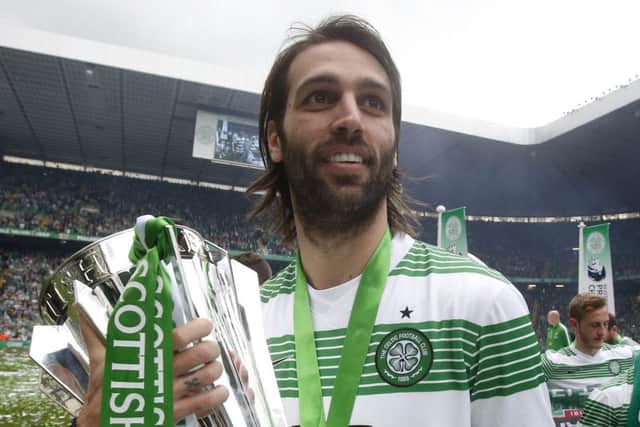 Departing striker Georgios Samaras holds the SPFL Premiership trophy after his goal helped the champions to a 3-1 win. Picture: PA