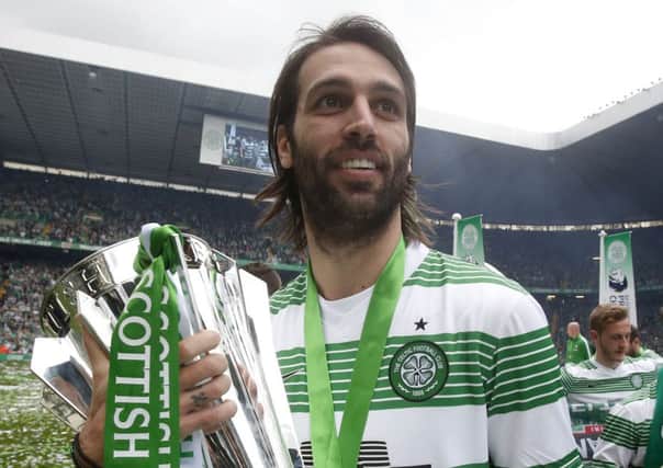 Departing striker Georgios Samaras holds the SPFL Premiership trophy after his goal helped the champions to a 3-1 win. Picture: PA