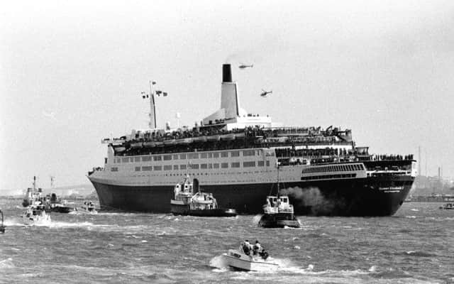 Troops line the rails of the QEII sailing up Southampton Water in 1982 as it heads off to join the Falklands Task Force. Picture: PA