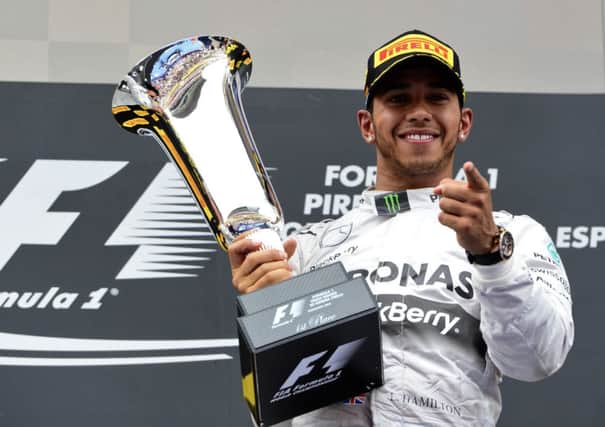 Mercedes driver Lewis Hamilton celebrates after winning the Spanish Grand Prix for his fourth victory in a row. Picture: AFP/Getty