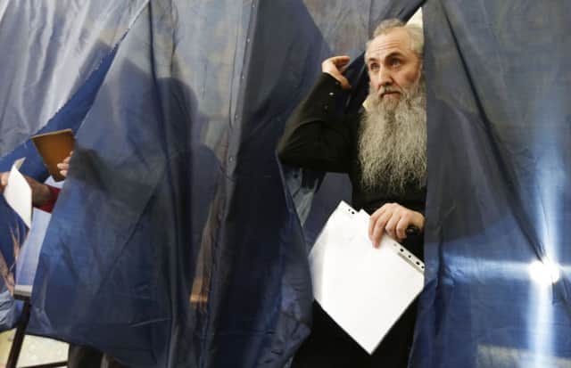 An elderly voter leaves a polling booth in Donetsk during the referendum at the weekend. Picture: Reuters