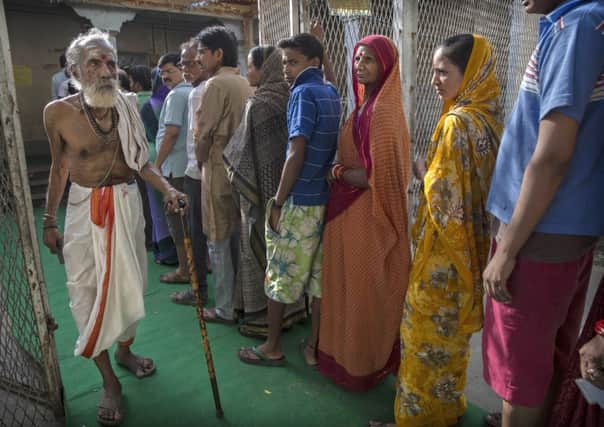 A Hindu holy man walks away after voting at a polling station in Varanasi. Picture: Getty Images
