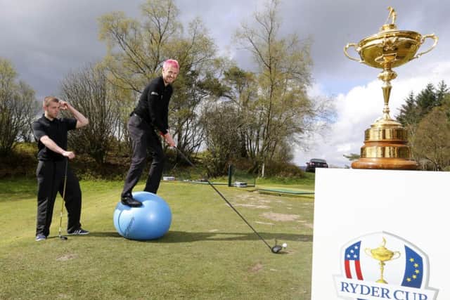Golf maestro Kevin Carpenter takes a shot as local youngster Brian Lawson looks on. Picture: Jeff Holmes/JSHPIX.CO