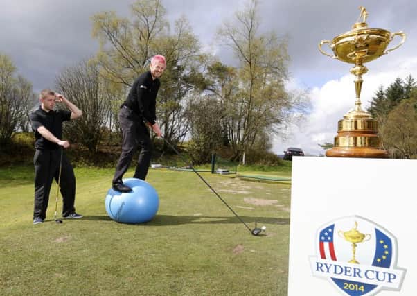 Golf maestro Kevin Carpenter takes a shot as local youngster Brian Lawson looks on. Picture: Jeff Holmes/JSHPIX.CO
