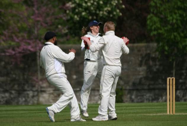 Arnie Sathiy and Michael Yellowlees congratulate Charlotte Bascombe on a catch. Picture: David Potter