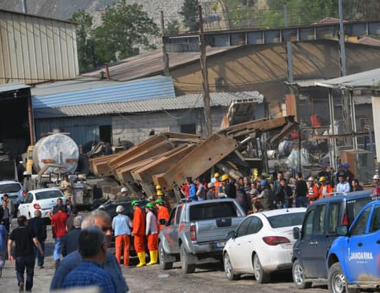 Rescuers in high-visibility clothing gather at the mines entrance in the town of Soma, 155 miles from Istanbul. Picture: AP